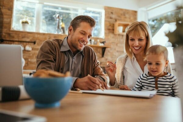 Two parents and child around a table