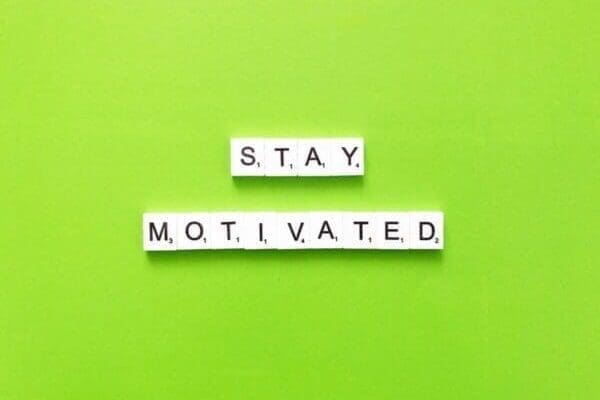 Stay motivated quote on green background