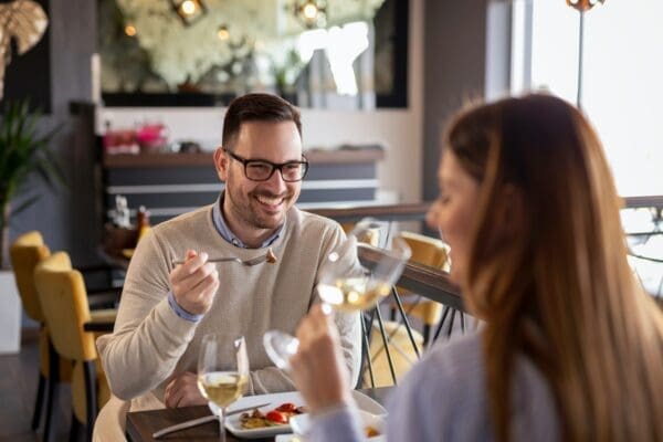 Two work colleagues at a restaurant eating 