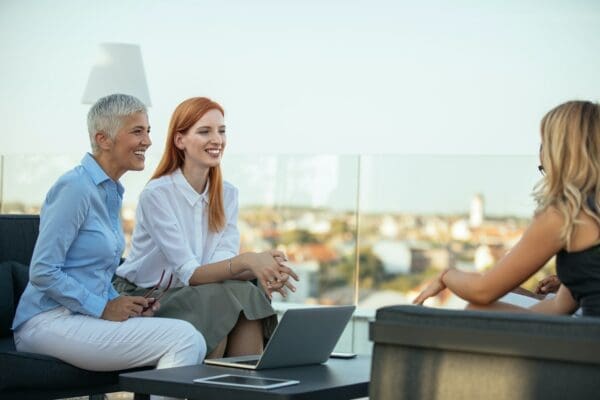 Female mentor coaches two female employees