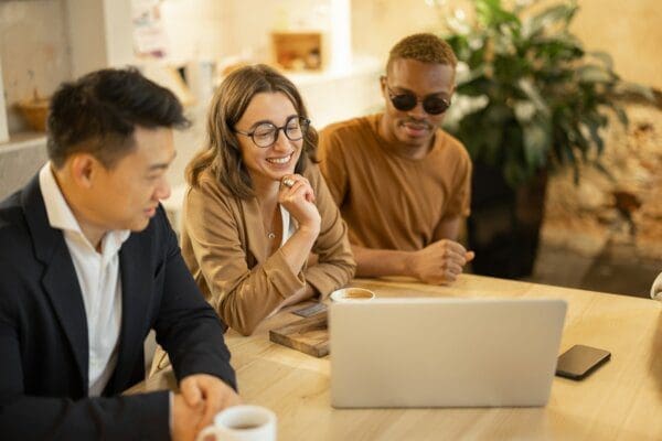 Diverse business team watching a video on a laptop