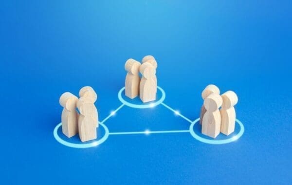 communication model with wooden people figures on blue background