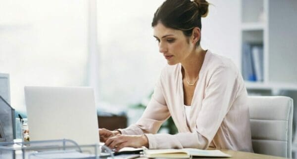 Female hard worker person working on her laptop