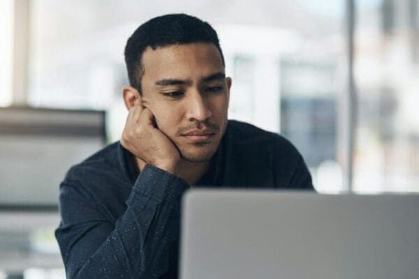 A male manager slouching during a boring presentation