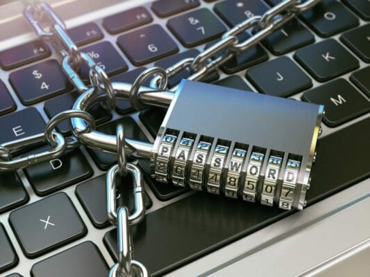 Padlock and chains across the keyboard of a computer.